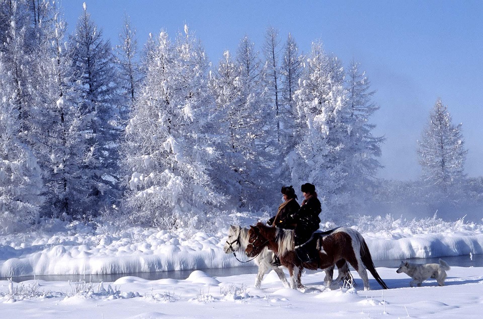 Winter horse riding couple in Mongolia